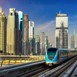 Commuters boarding Dubai Metro with skyline in background